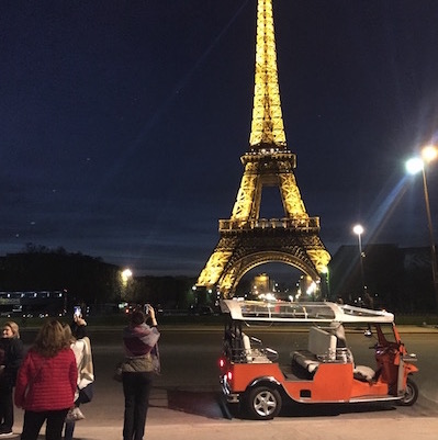 tuktuk at the eiffel tower by night