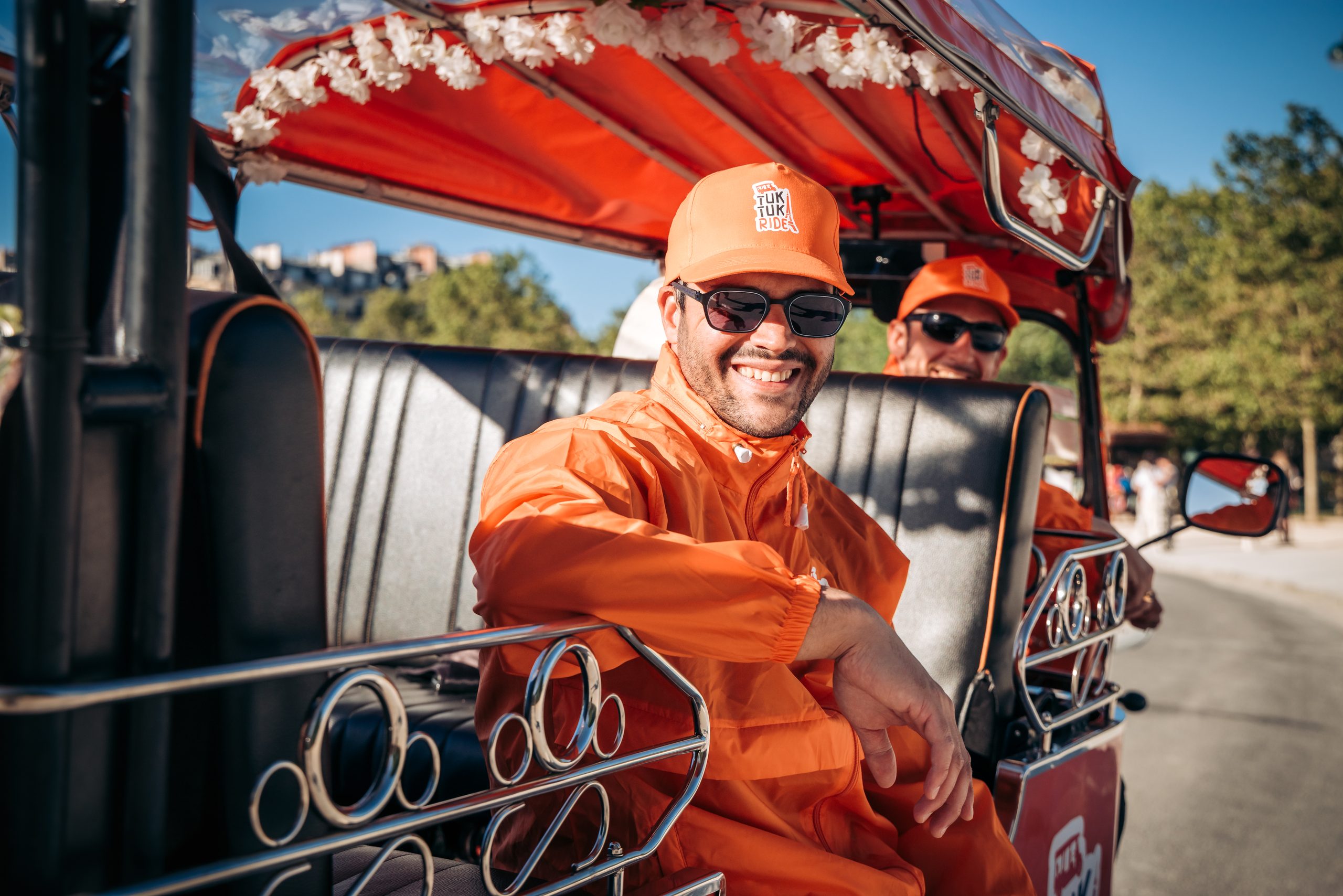 Chauffeur Tuktuk Ride en tenue orange à bord d'un tuktuk électrique à Paris